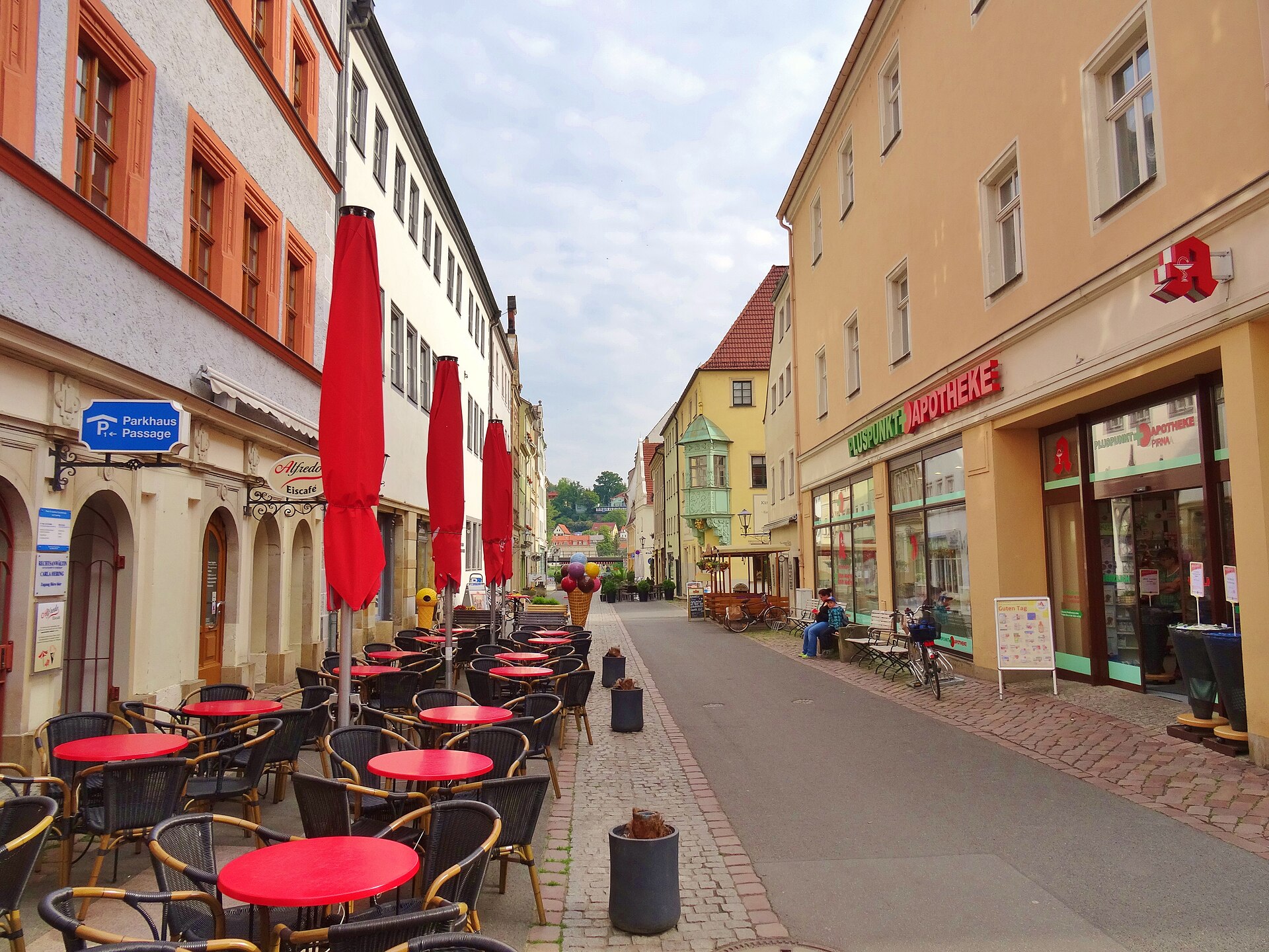 The Dohnaische Straße Pirna. During the morning the people walking in the street. Children come with their teachers walking over the square and begging for being photographed. Old peoples watching out of the windows. The weather is fresh and you breath clean air. Nobody discriminates each other not even with a bad view.